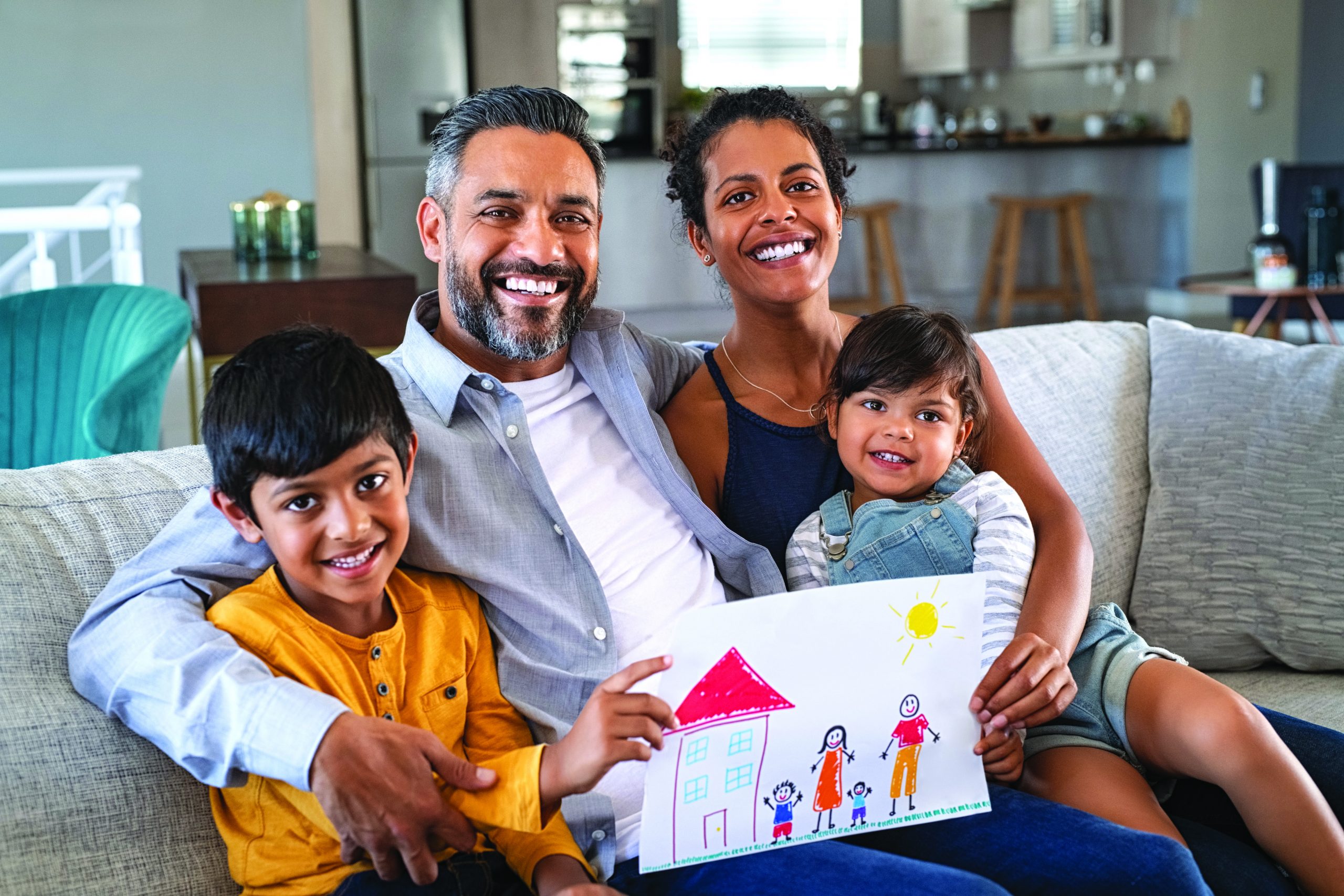 Proud,Parents,Showing,Family,Painting,Of,Son,And,Daughter,Sitting