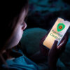 A,Child,Using,Smart,Phone,Lying,In,Bed,Late,At