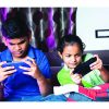 Siblings,Busy,Playing,Video,Game,On,Mobile,Phone,During,Night