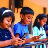 Group,Of,Kids,Busy,Using,Mobile,Phone,At,School,Corridor
