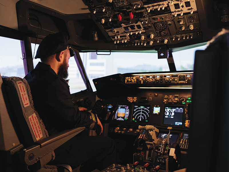 Caucasian plane captain getting ready to takeoff and fly airplane