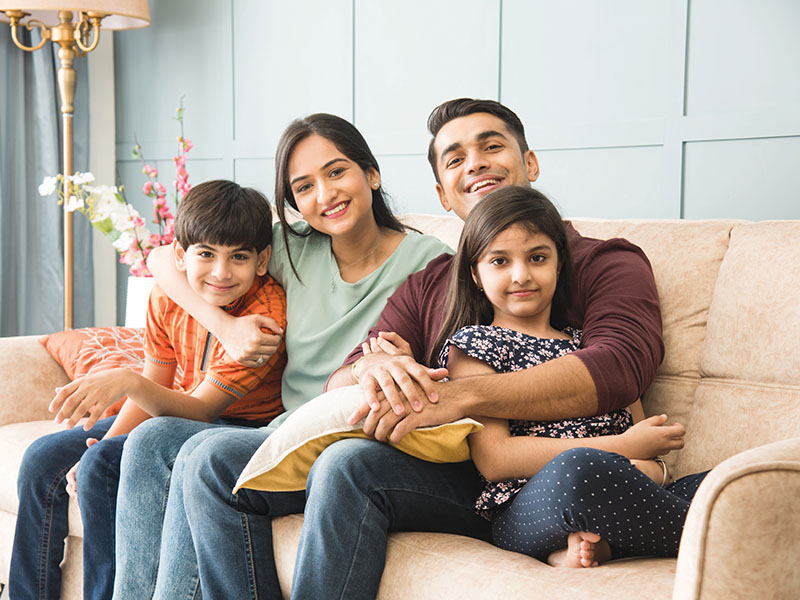 Portrait,Of,Happy,Indian,Asian,Young,Family,While,Sitting,On