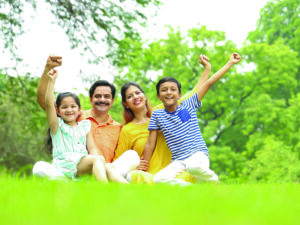 A,Happy,Family,Sitting,In,A,City,Park,Early,Morning
