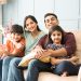 Portrait,Of,Happy,Indian,Asian,Young,Family,While,Sitting,On